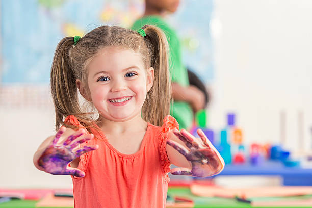 istock Sweet preschooler has fun with finger paints 599899926