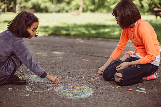 istock Kids drawing with chalk on asphalt 599903054
