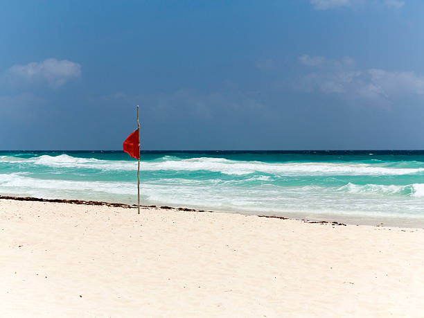 istock Flag on Caribbean beach, Cancun, Mexico 599903386