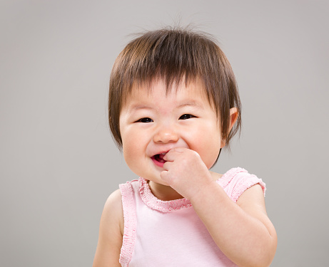Asian toddler sucking fingers