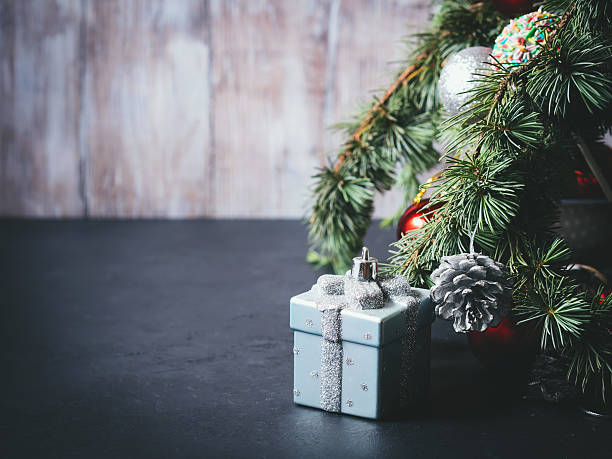 istock Blue spruce tree branches with Christmas ornaments on black 599905384