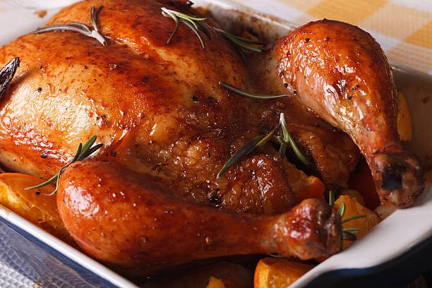 istock baked chicken with oranges in the baking dish close-up. horizontal 599905418