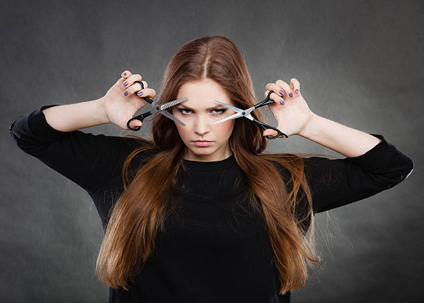 Style and fashion. Professional hairstylist barber with new idea of look changing. Long haired woman with scissors creating hairdo coiffure.