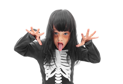 Little Asian girl in Halloween zombie make up isolated on white background