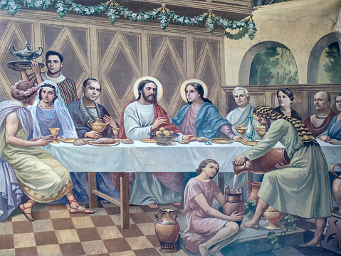 Rome, Italy - August 6, 2016: inside the church of S. Maria Immacolata e S. Giovanni Berchmans. The painting depicts Jesus and his mother at Cana during the banquet for the marriage as reported in the Gospel (Jn 2,3-5). Fresco painted by Mario Prayer (1887-1959). He was an Italian painter, mainly of frescoes for churches or large halls.