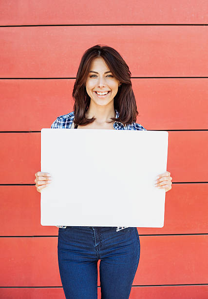istock Happy woman showing white banner 599908578