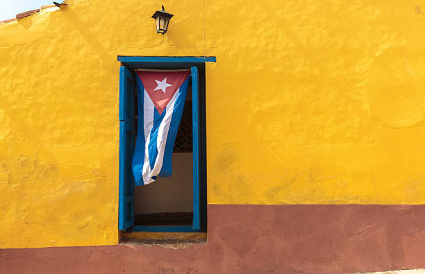 Cuba Cuban flag hanging on a door in Trinidad, Cuba havana photos stock pictures, royalty-free photos & images