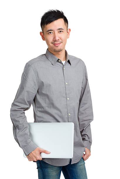 istock Chinese man holding a laptop 599908798