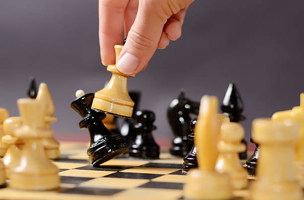 istock Playing chess. White queen Hitting the black one in front 599909472