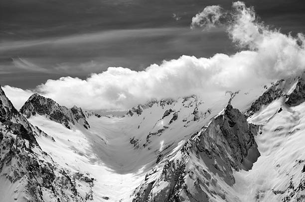 istock Black and white winter mountains in clouds 599910170