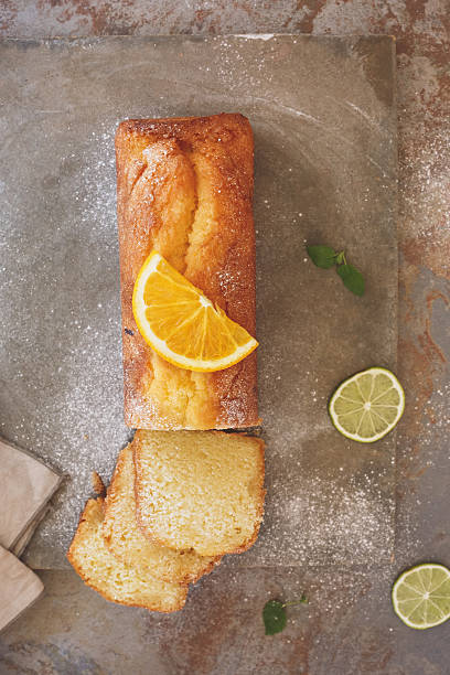 istock Orange cake drizzled with icing sugar, partly sliced 599911668