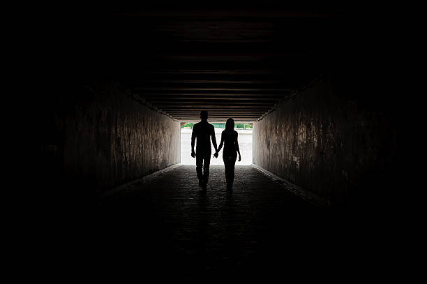 istock Silhouette of young couple holding hands 599911976