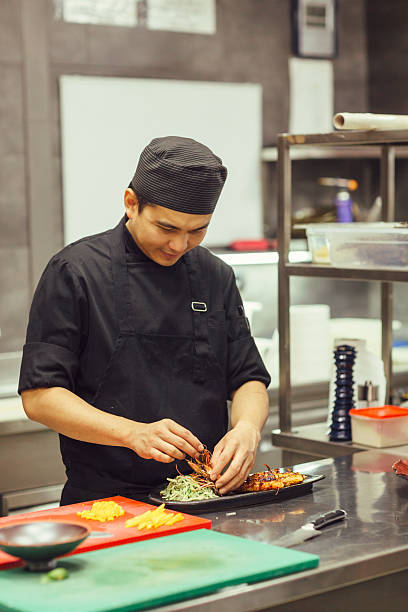 istock Chef Preparing Grilled King Prawn Meal 599912294