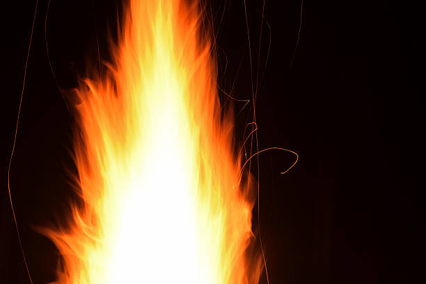 istock bright flame fire and sparkle at night, closeup 599914460