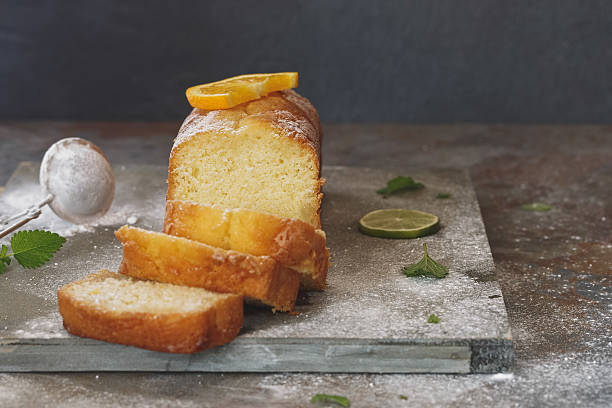 Orange cake partly sliced and fresh fruits