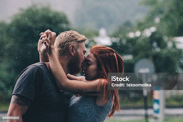 Beautiful Couple Kissing In The Rain Stock Photo - Download Image Now -  Rain, Kissing, Couple - Relationship - iStock