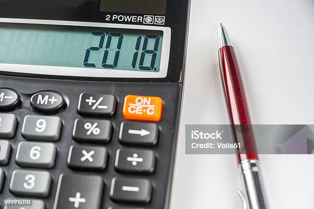 The 2018 Year On The Calculator And Pen Stock Photo - Download Image Now - 2018, Backgrounds, Balance