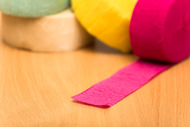 istock Colorful rolled paper decorative ribbons on wooden table 599921346