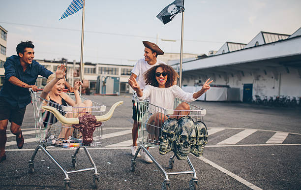istock Young friends having fun on a shopping trolleys 599922358