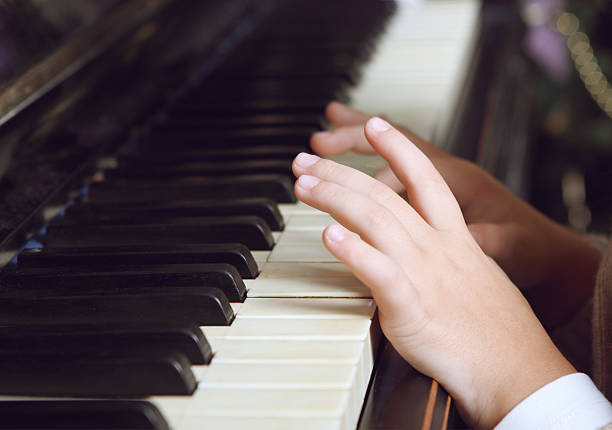 istock Child playing the piano 599922362