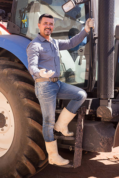 istock Mature farmer near tractor 599922382