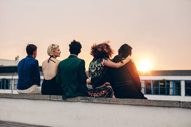 istock Friends relaxing on terrace in evening 599922762