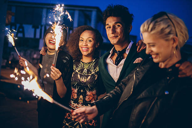 istock Friends at night with fireworks enjoying party 599923070