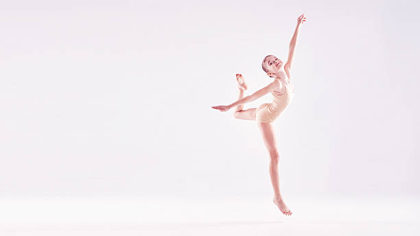 istock Young excited girl jumping in the studio 599923204