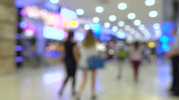istock Defocused young women walking in modern shopping mall 599953874