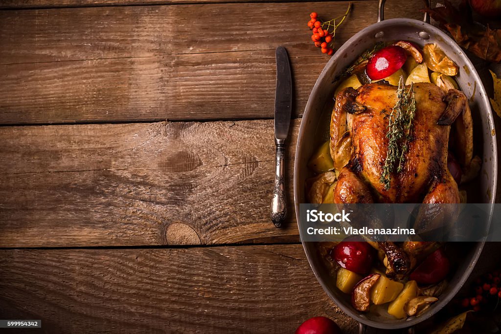 Served roasted stuffed Thanksgiving Turkey. Top view.Space for text. Served roasted stuffed Thanksgiving Turkey and vegetables from above and blank space. Style rustic. Turkey Meat Stock Photo