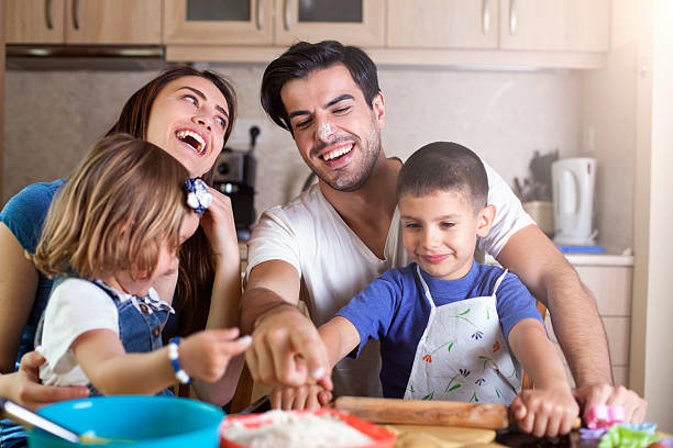 istock Happy family baking cookies 599954538
