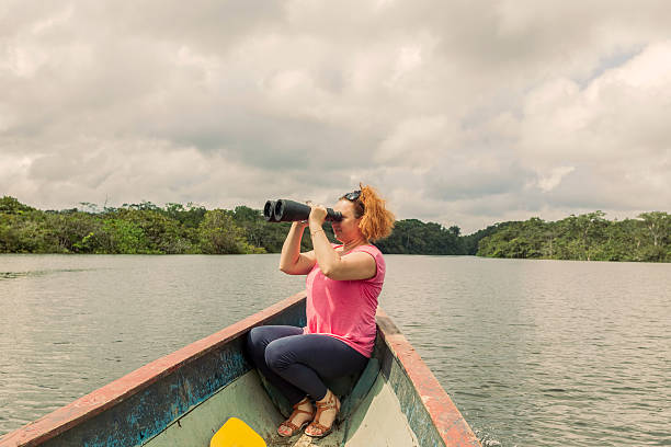 istock Blonde Woman With High Power Binocular 599957902