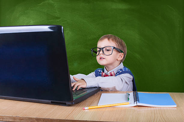 istock Child with laptop peeking in the classroom 599959244