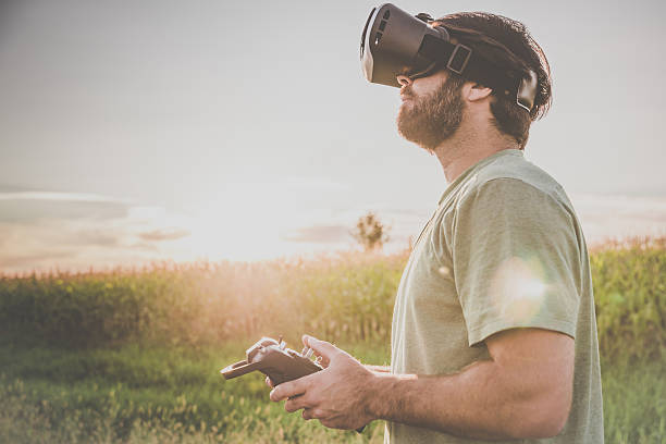 istock Man Flying a Drone with Virtual Reality Goggles Headset 599959560