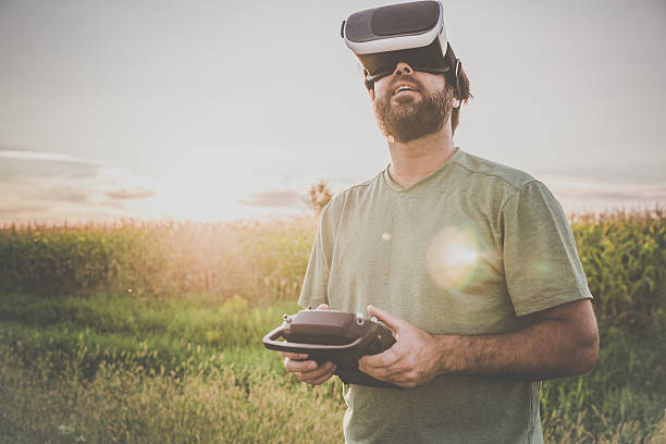 istock Man Flying a Drone with Virtual Reality Goggles Headset 599959576