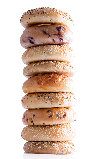 Close up Tasty Homemade Bagel Breads Piled Vertically, Isolated on a White Background.