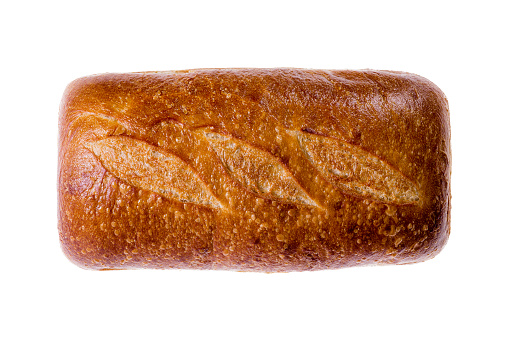 Rectangular fresh loaf of sourdough bread with a crusty top viewed from above isolated on white centered in the frame