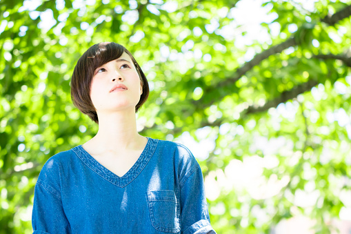 Japanese young woman portrait in the fresh green.