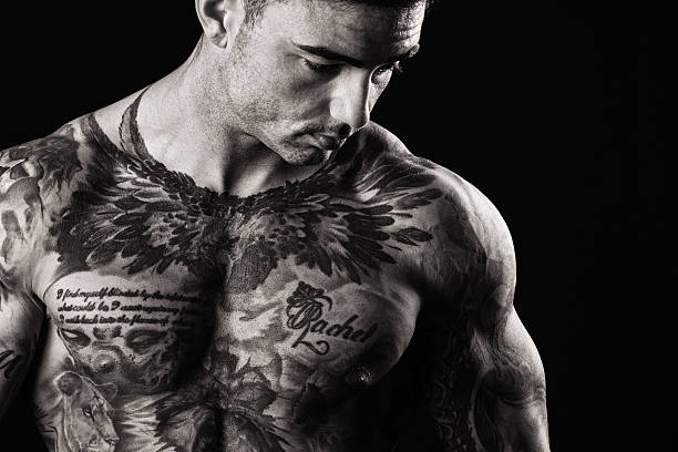 istock Tattooed Muscular Man Looking Sullen 599963456