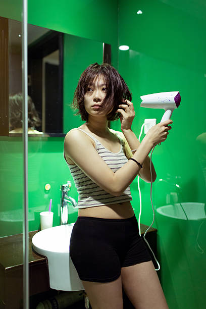 girl in the bathroom pretty young girl standing in the bathroom to scrub finishing her hair short human hair women little girls stock pictures, royalty-free photos & images