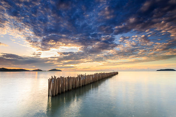 istock Bamboo wall in the sea and beautiful sunrise 599968072