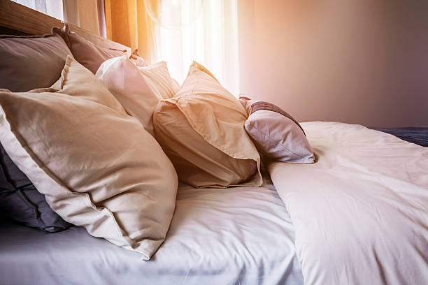 istock Bed maid-up with clean white pillows and bed sheets 599968720