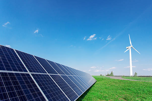 istock Windmill and solar panels on blue sky at daytime 599972310