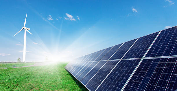 istock Windmill and solar panels on blue sky at daytime 599972348