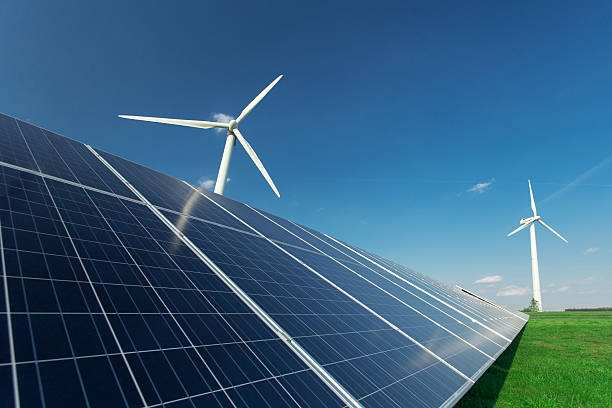 istock Windmill and solar panels on blue sky at daytime 599972648