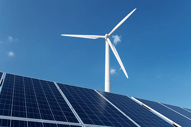 istock Windmill and solar panels on blue sky at daytime 599972690