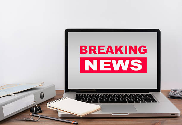 istock Breaking News. Office desk with a laptop 599973406