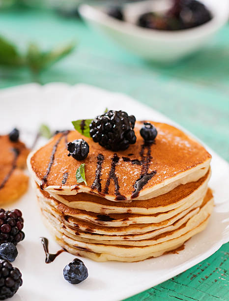 Delicious pancakes with blackberries and chocolate.