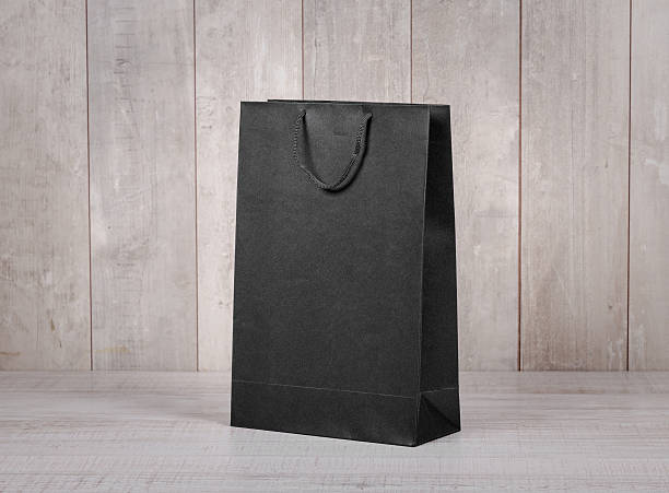 istock Paper shopping bag on wooden table 599976464