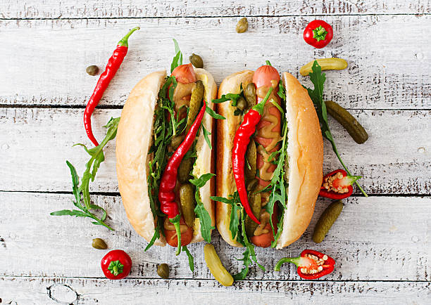 istock Hot dog with pickles, capers and arugula 599976538